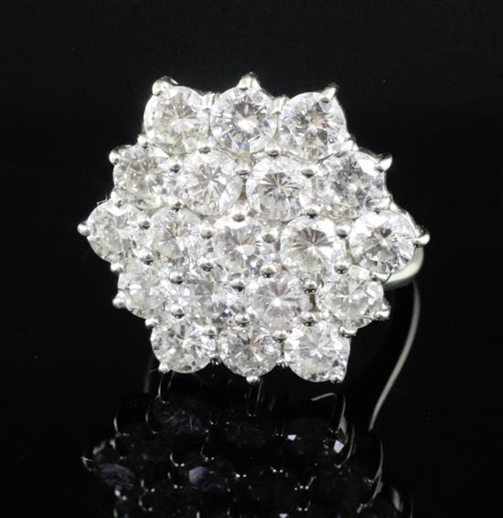 An 18ct white gold and diamond hexagonal cluster ring, size K.